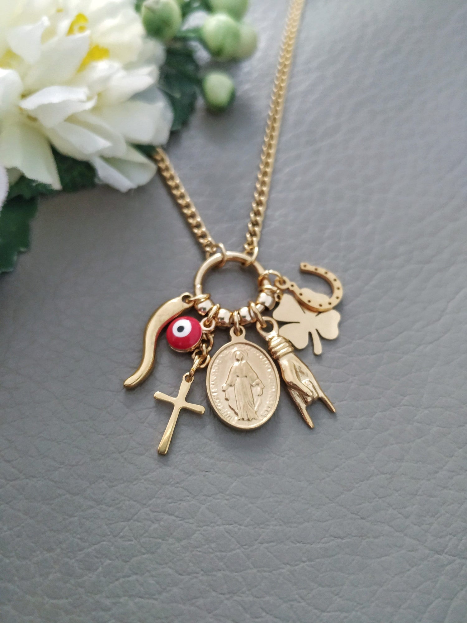 Italian amulets like horn cornicello, mano corno horned hand, Mallochio evil eye charms necklace