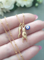 Italian good luck charms, gold cornicello horn blue eye necklace